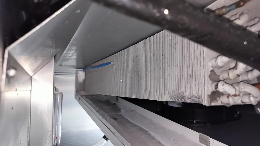 Frost accumulation on a refrigeration evaporator coil during inspection.