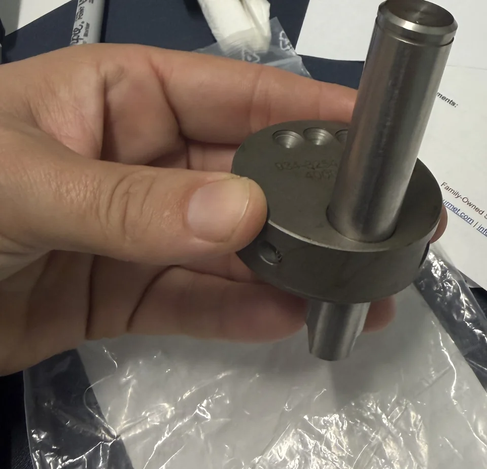 Close-up of a shaft and flanged metal adjustment component