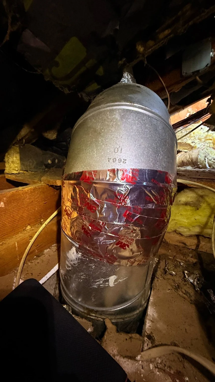 Second view of the repaired metal kitchen exhaust duct connection inside the attic