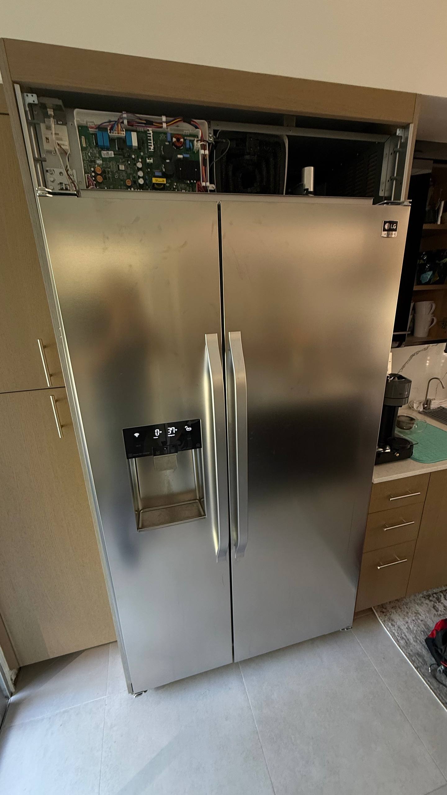 LG LSSB2692ST built-in refrigerator with the upper service compartment exposed during a Sunnyvale inspection.