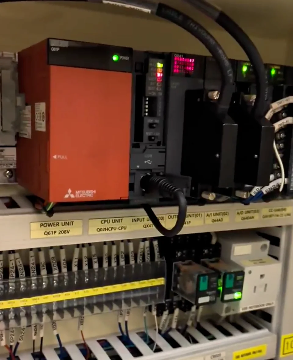Mitsubishi MELSEC-Q controller and power-supply modules inside the industrial mixer cabinet