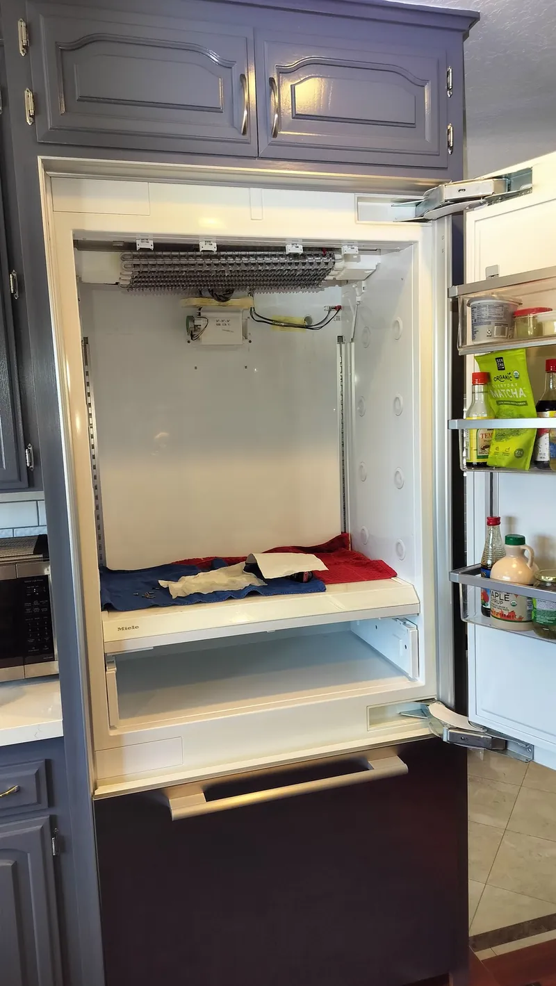 Miele built-in refrigerator interior opened for evaporator and airflow inspection.