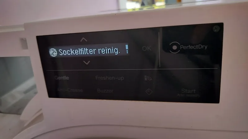 Miele TXI680WP heat-pump dryer display showing a clean plinth filter message during service.